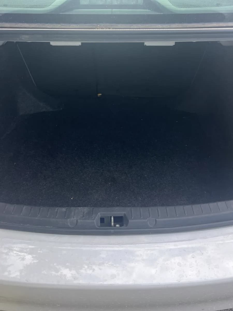 Trunk with dirty bumper lip — before